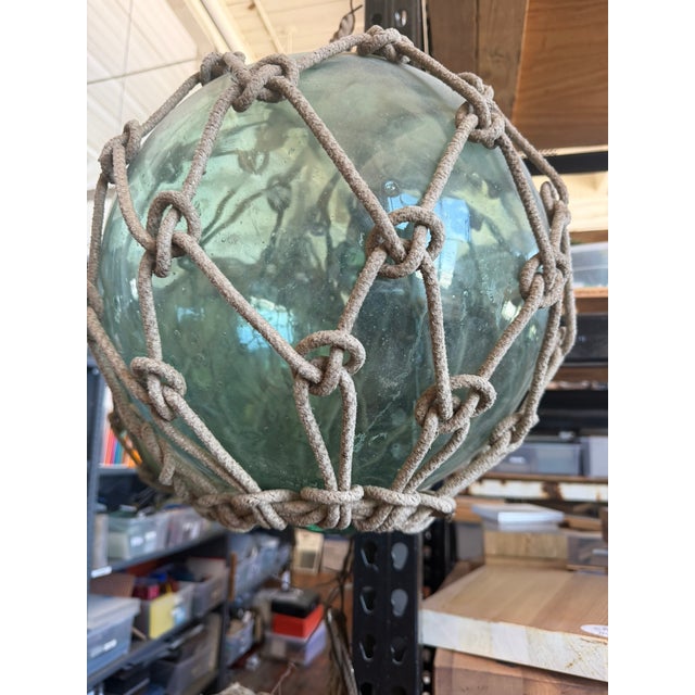 These antique Japanese glass fishing floats are hand‑blown in the traditional style used by fishermen throughout the...