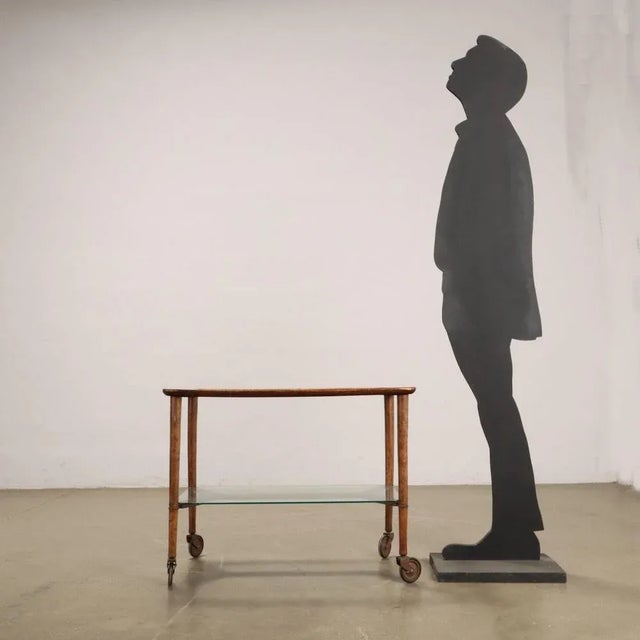 Double-deck service trolley in beech wood and glass. This piece is attributed to the mentioned designer/maker. It has no...