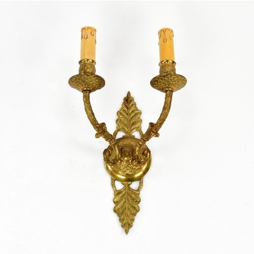 Empire-style wall lamp made in France in the 1930s. Luxurious brass wall lamp that will bring elegance and a glamorous...