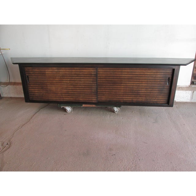 Sleek vintage custom made floating wall mount wooden console. Eight feet long. Features a pair of sliding doors which open...