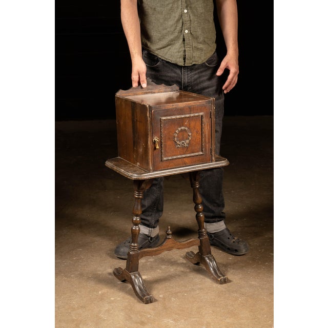 Early 20th-century Colonial Revival smoking stand constructed from walnut and incorporating a copper-lined humidor...