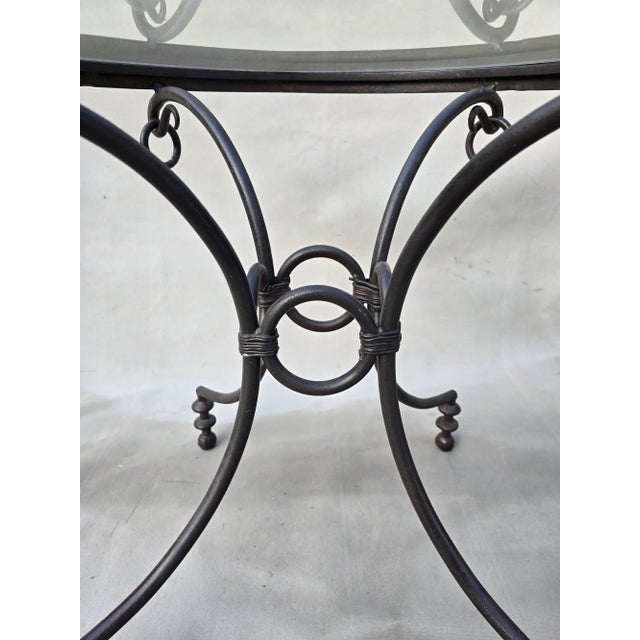 This is a beautiful wrought iron glass table with unique round door pull hanging accents. This table could be used in your...