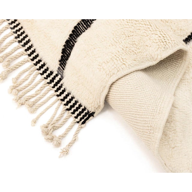 Elegant hand-knotted rug with a modern handwoven abstract design in Black on an Ivory background, crafted from wool for...