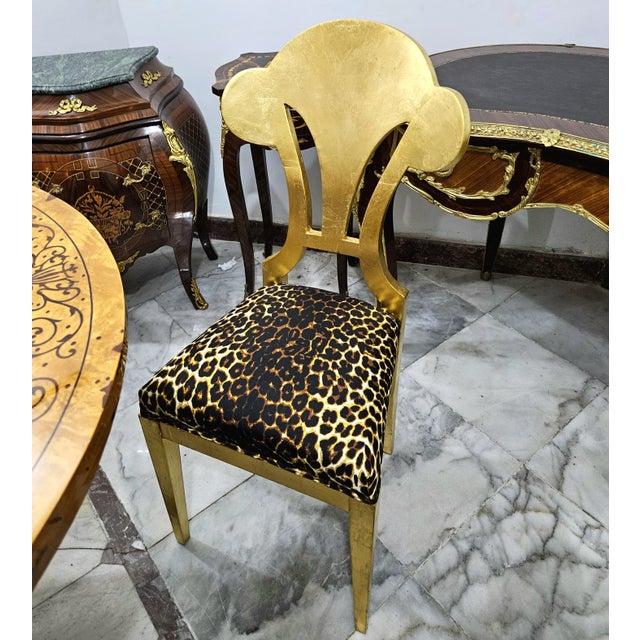 Make a bold statement with this French-inspired accent chair, featuring a striking leopard print upholstery paired with an...