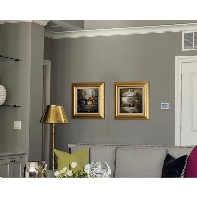 Beautiful original oil paintings (2) on canvas depicting still life scenes of 1) a covered vase on a table with plums and...