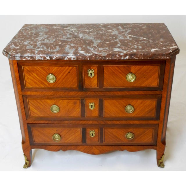 Cabriole legs grace this marble top chest with Ormolu detailing. The top section is two drawers and the bottom two...