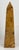 A hand-carved banded onyx obelisk, polished to a lustrous shine. Warm layers of brown, amber, and butterscotch ribbon...