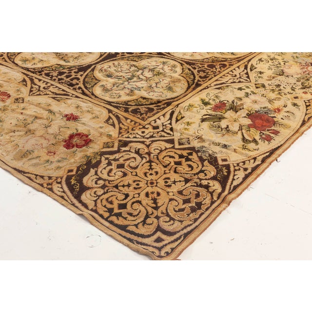 A magnificent example of late 19th-century British textile artistry, this antique English needlework rug from the 1880s is...