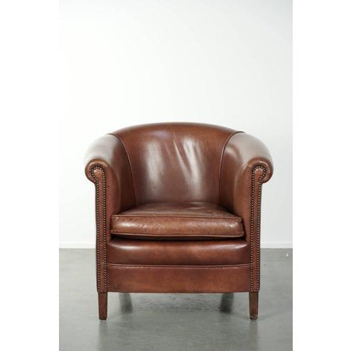 We are offering this English-style cowhide leather club armchair in a beautiful dark cognac color, finished with...