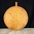 French round bread board or dough board, handcrafted from solid hardwood pine with a shaped handle and a warm, naturally...