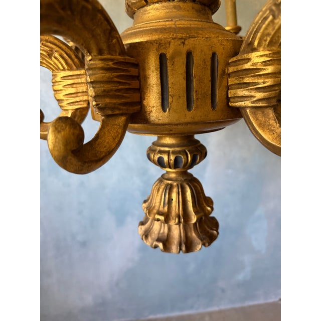 Large Neoclassical gilt wood six light chandelier. The leaf knopped standard issuing drum into six S scrolled arms.