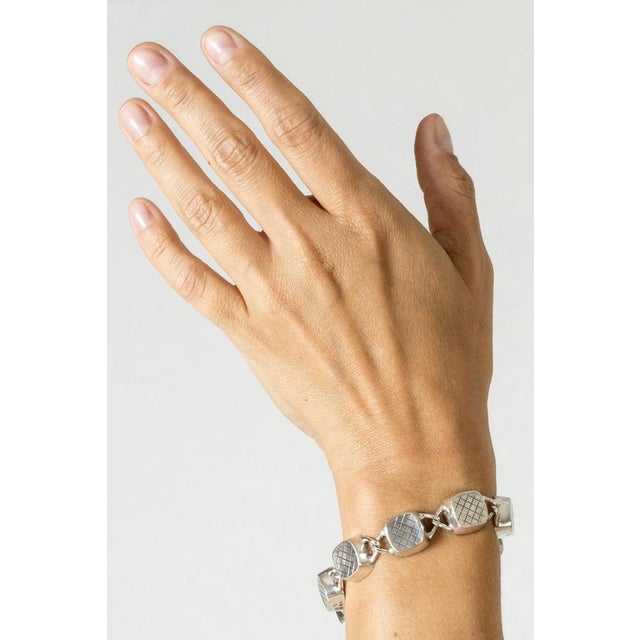 Elegant silver bracelet by Sigurd Persson, in his classic “Squares” design, adorned with a crisp checkered pattern. A...