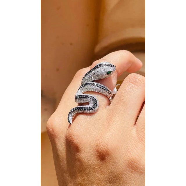 Tsavorite Eye and Diamond Snake Coil Ring in 18K Gold featuring natural diamonds of 3.5 carats and tsavorite of 0.1 carat....