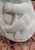 A mid-century stone sculpture modeled after Rima Padova of a mother and child. Probably made of limestone with some...