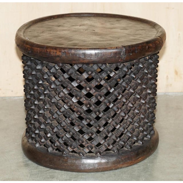 Stunning, ornately hand carved from a single tree trunk, Bamileke side table or stool from Cameroon Please note: The...