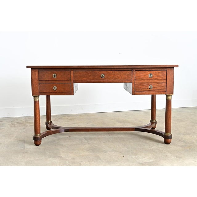 A handsome French Empire desk made of mahogany that has been recently refinished to preserve the beautiful color and grain...