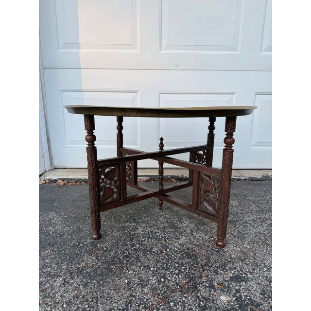 Moorish collapsible four Legged Folding Side Table and Brass Tray Top. A hand carved turned wood base of 4 legs supports...