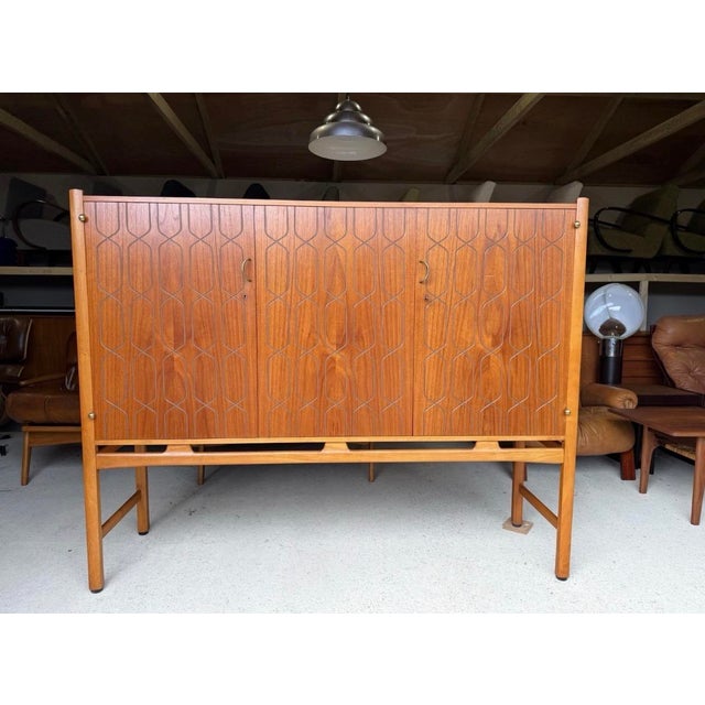 Stunning Swedish designed high sideboard, made out of teak, beech and brass. The model is called “Napoli”. Extremely...