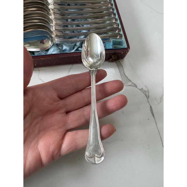A complete set of 12 Chinon pattern coffee or dessert spoon in original box. The Chinon pattern was first created in 1862....