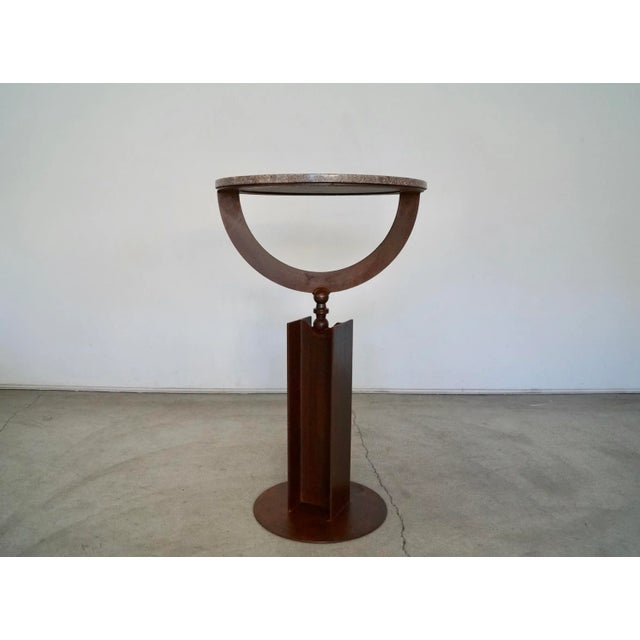 Gorgeous industrial cast iron pedestal with a round marble top. The metal base has a beautiful patinated finish with an...