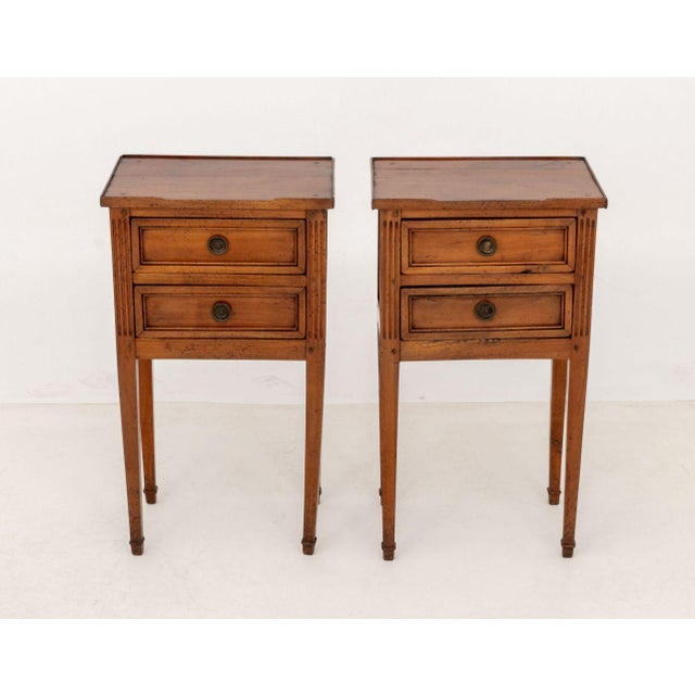 Pair of Louis XVI Style Fruitwood Bedside Tables, each with two drawers on fluted tapered legs. 28.5" H x 15.75" W x 11"...