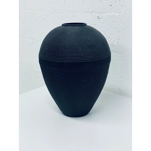 Corrugated cardboard vase rendered in matte black by Flute, Chicago circa 1980s. Best to use with dried arrangements.