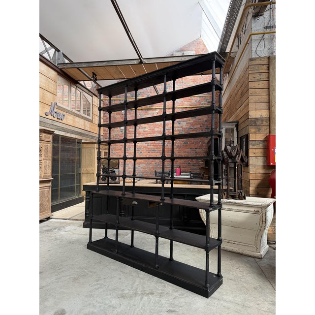 This very large display shelf, from the 1980s, is made of patinated wood and has been fully restored. It consists of a...
