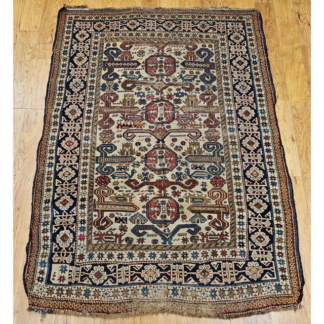 A late 19th century Caucasian Shirvan "Perpedil" area rug, meticulously hand-knotted in the late 1800s. While "Perpedil"...
