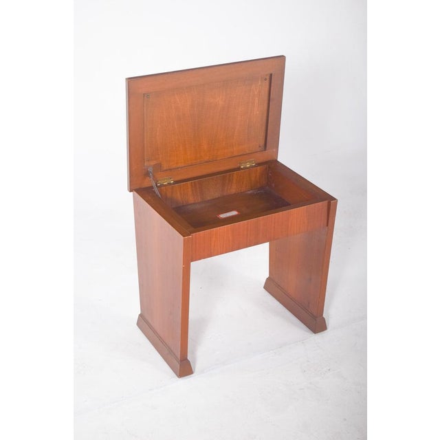 Wooden piano bench. with a light varnish finish, straight lines and a sturdy structure, characteristic of mid-20th century...