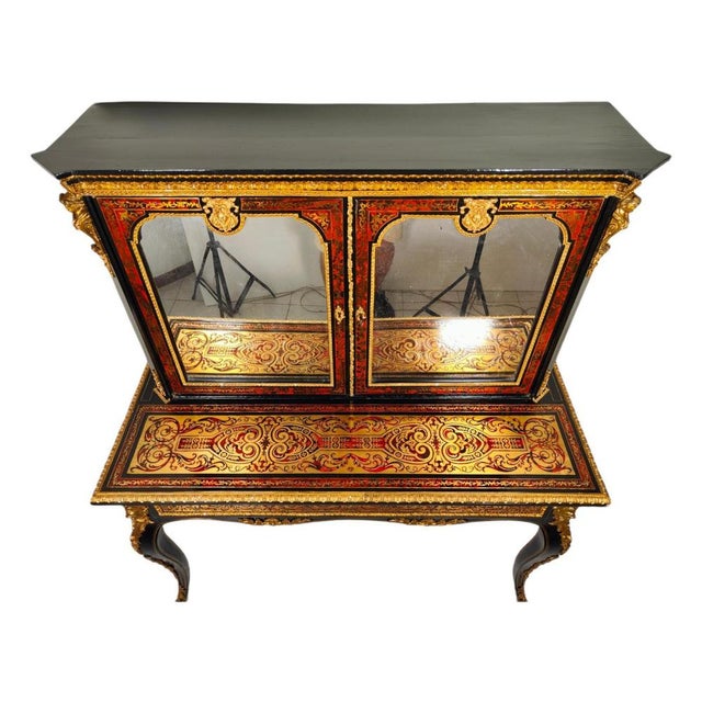 XIXth Century ebonised Boulle Bonheur Du Jour cabinet.The top has ornate brass mounts, flanked by brass gilded cariatides....