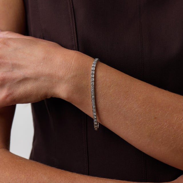 This elegant Art Deco diamond tennis bracelet is a beautifully refined jewel from the 1920’s, set with 49 old European cut...
