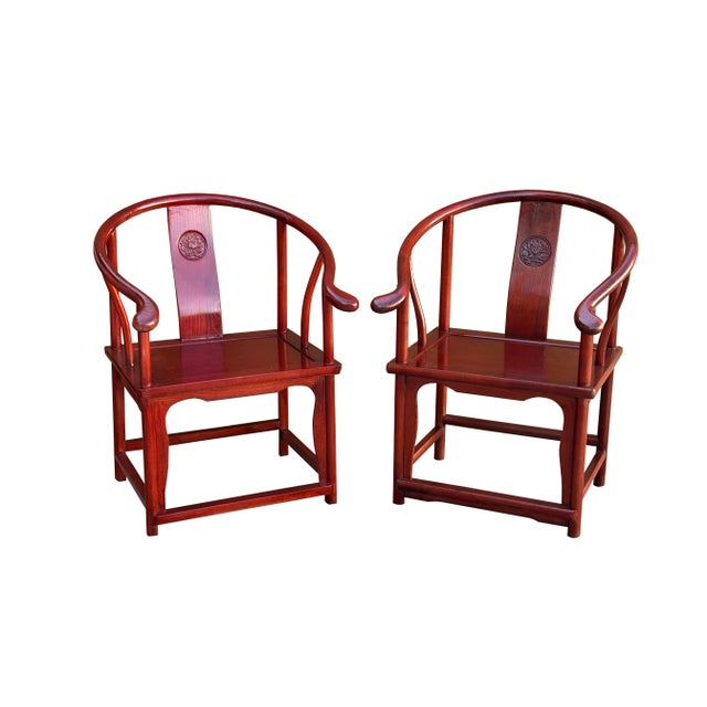 Elevate your living space with this stunning pair of authentic Ming-style horseshoe armchairs, masterfully crafted from...