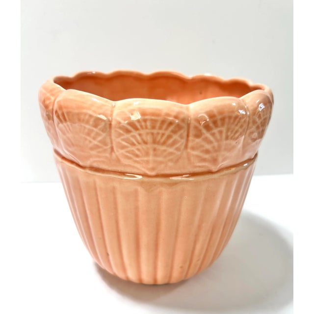A charming 1960s vintage ceramic clamshell cachepot planter in a soft peach tone. The ribbed lower body and repeating...