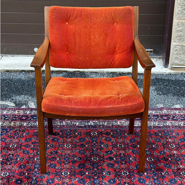 Genuine Gunlocke solid walnut chair with orange uphostery and sculpted arms. Signed with metal tag embedded into the back...
