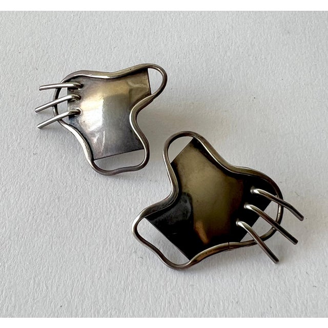 Sterling silver 1950's freeform earrings with screw back fasteners by Carolyn Gleick Rosene of San Francisco, California....