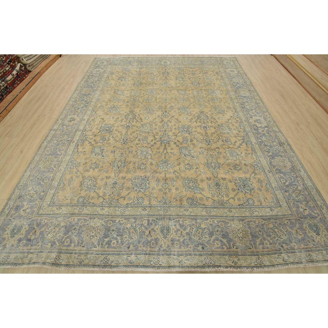 An authentic vintage traditional Tabriz rug hand-knotted with fine wool and natural dyes. This oriental rug features an...