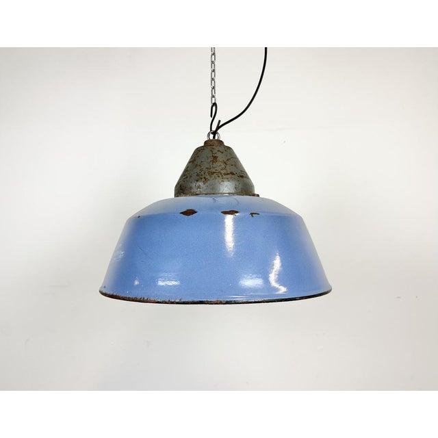 Industrial hanging lamp manufactured by Szarvasi Vas - Fém in Hungary during the 1960s. It features a blue enamel shade,...