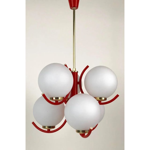 A beautiful pendant lamp in coral color with brass trim. The 6 glass globes are mat opaline glass. European Plug (up to...
