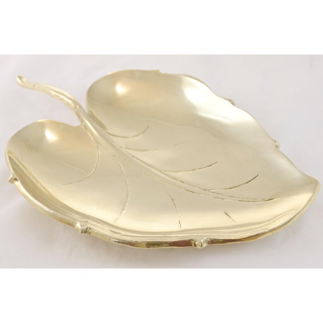 Large vintage solid cast brass leaf with engraved veins and a stem handle. Use as an entryway catchall dish or coffee...