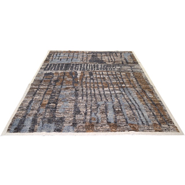 Hand-knotted with care using traditional rug-making techniques, this wool rug blends timeless craftsmanship with a modern...