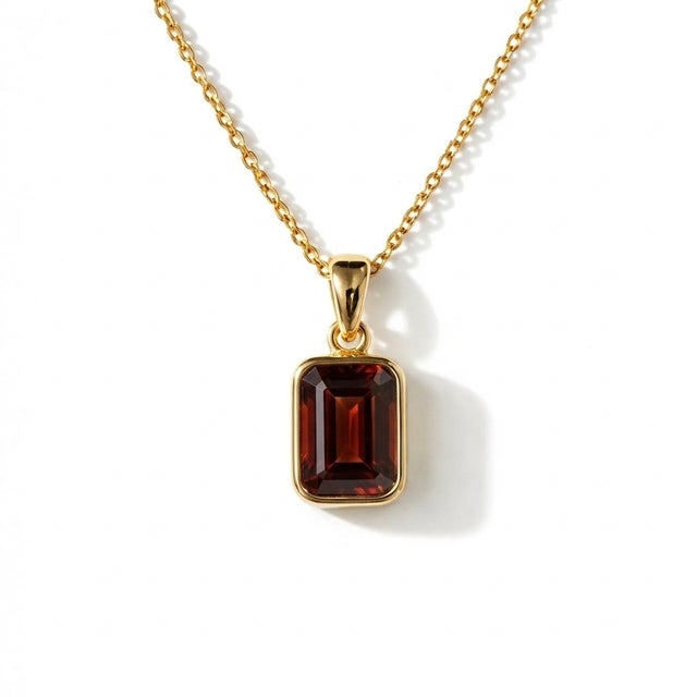 Emerald-Cut Garnet Pendant Necklace – January Birthstone This elegant pendant necklace showcases a captivating garnet...