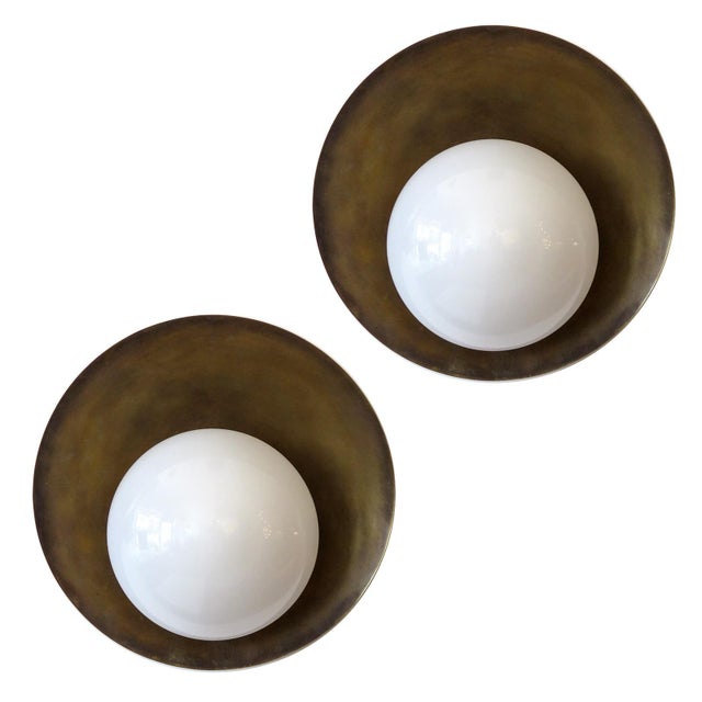 Elegant custom "Concha" wall light designed by Gallery L7, opaline glass shade on a patinated raw brass disc, multiples...