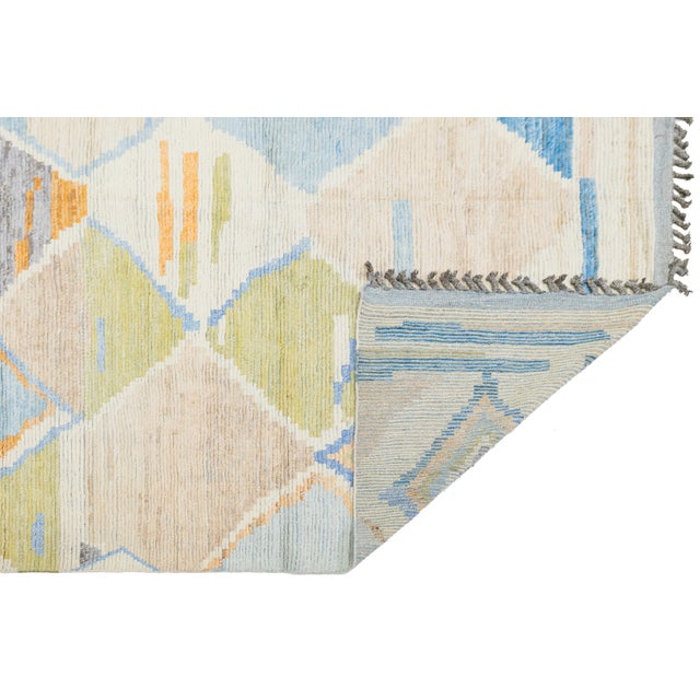 Elevate your space with this modern Moroccan-style rug, featuring a sophisticated interplay of geometric diamond motifs...