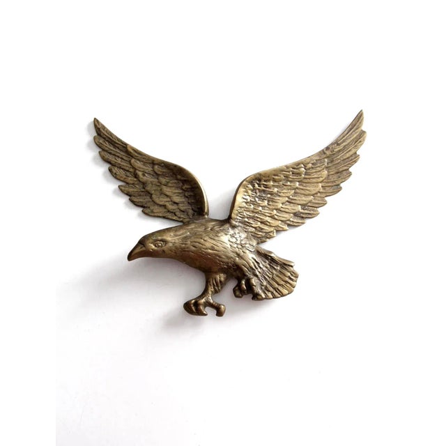 This is a vintage brass eagle wall hanging. Shaped as an American eagle spreading its wings, the wall decor has nice...
