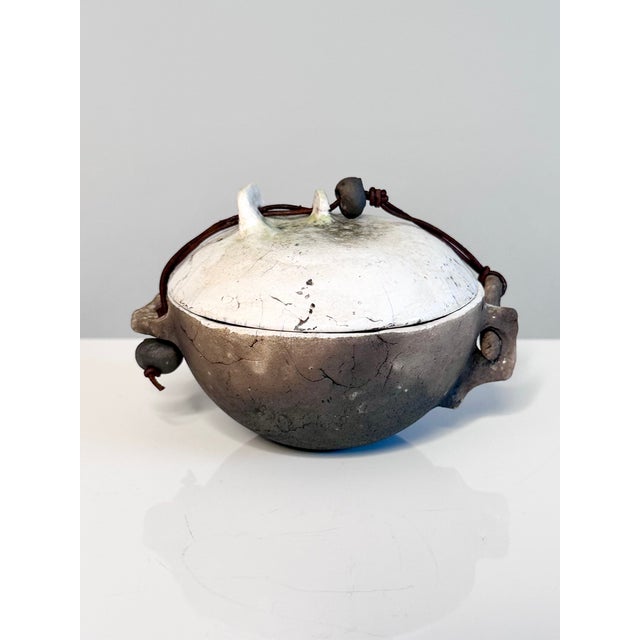 This irregularly shaped lidded box is a distinctive example of handmade Raku ceramics from the 1980s. The rough, vibrantly...