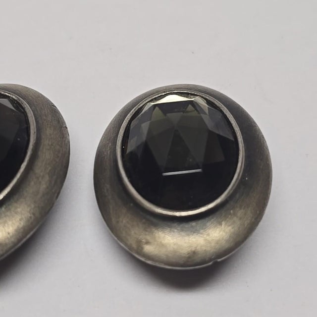 This stunning pair of 1970s Ben-Amun Smoky Quartz and Silver Oval Earrings is sure to garner lots of oohs and aahs with...
