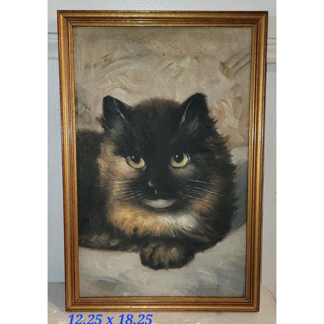 Vintage framed oil painting of a tortoise shell cat. This painting show the cat being aware of its surroundings with a...
