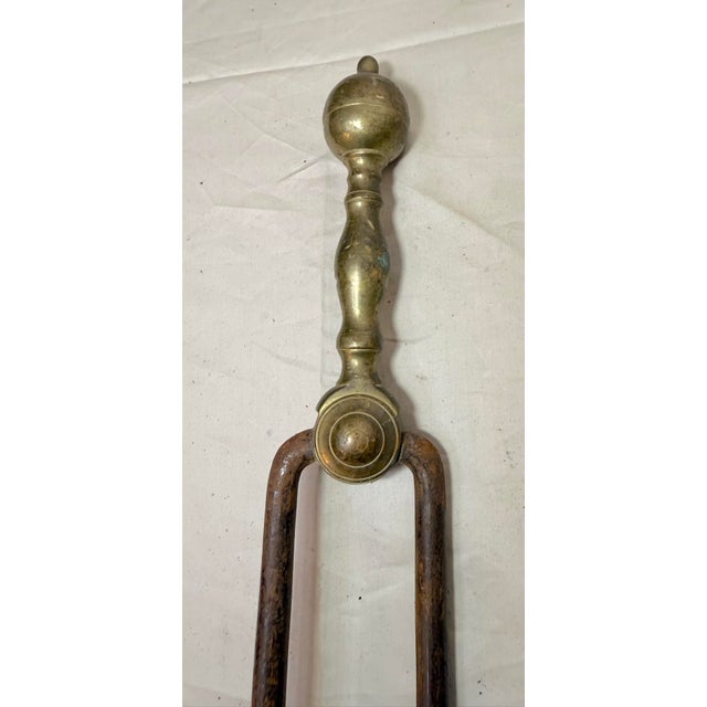 Up for sale is a nice pair of rare antique 18th century wrought iron and brass English fireplace tongs. The arms are...
