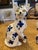 Elegant pair of Faience ceramic cats in blue and white floral pattern with yellow eyes. One of the back paws is missing -...