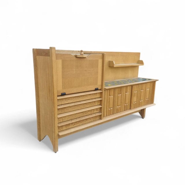 Guillerme & Chambron sideboard 1960 for “Votre Maison”. It opens with a flap, forming a bar or secretary, in the left part...